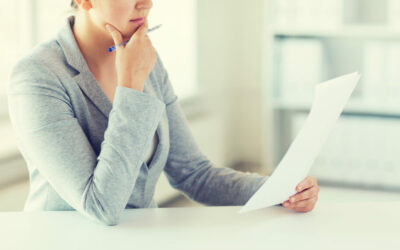 Woman looking at paper considering if she should get a lawyer