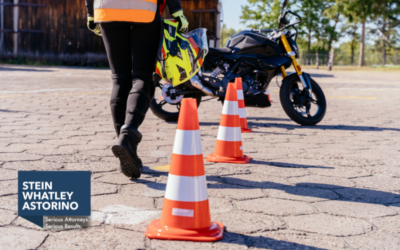 Orange cones and motorcycle with instructor walking.